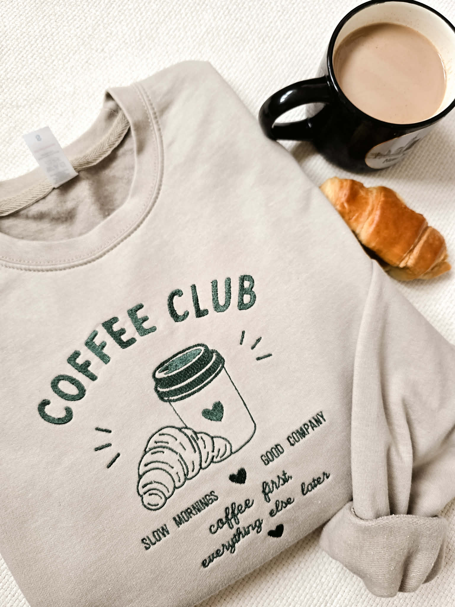 Embroidered Coffee Club sweatshirt featuring a hand-drawn coffee cup and croissant design. A cosy heavyweight sweatshirt inspired by café mornings, slow living and everyday comfort. Designed and embroidered in Cornwall.