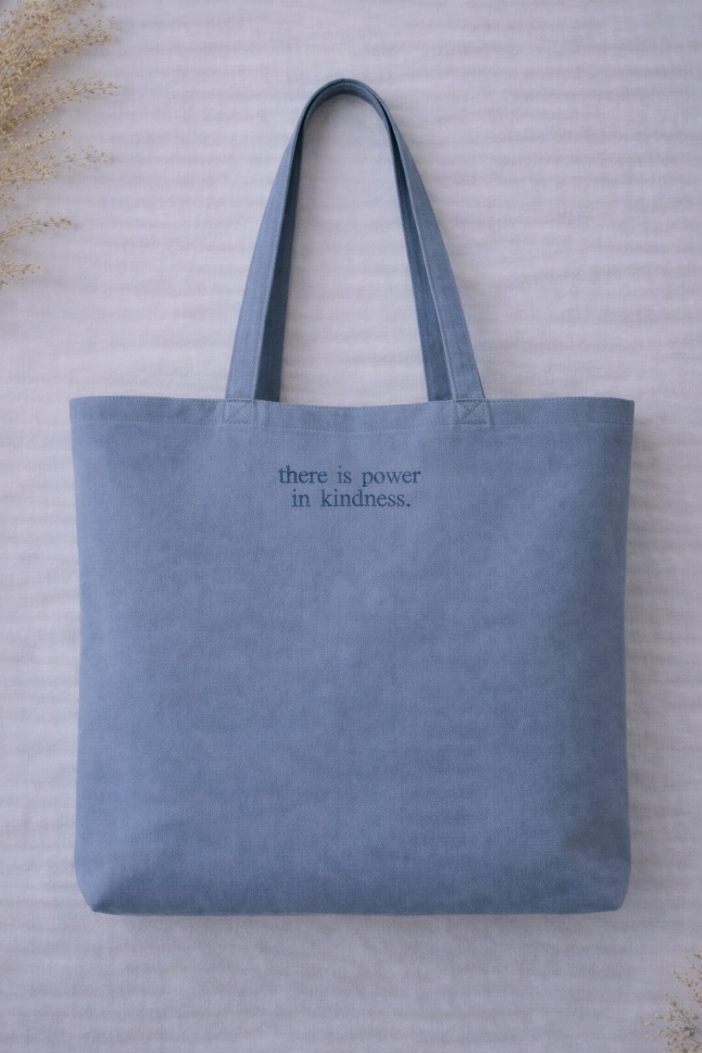 Blue organic cotton tote bag personalised with custom embroidered quote chosen by the customer